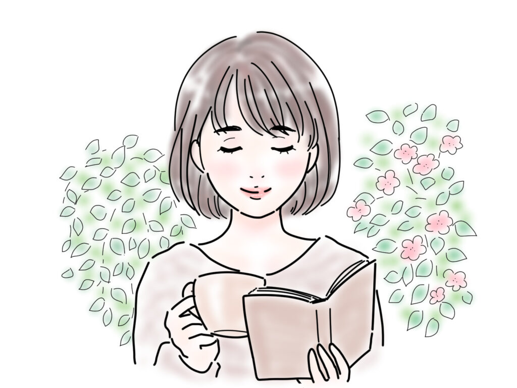 お茶を飲みながら読書する女性